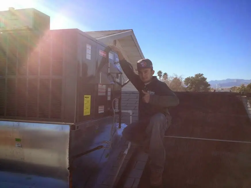 HVAC technician performing Heat Pump Repair on a rooftop unit in Irmo